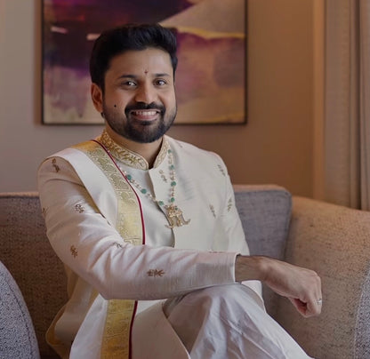 Beige & gold sherwani with dhothi-kanduva set for the groom