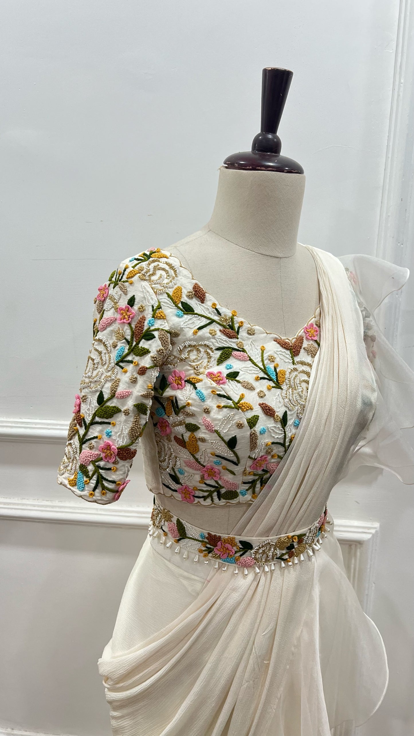 Off White Ruffle Saree paired with raw silk thread and knot work blouse