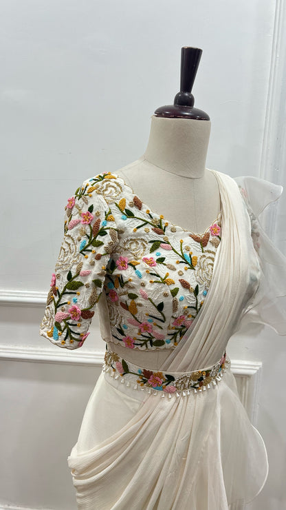 Off White Ruffle Saree paired with raw silk thread and knot work blouse