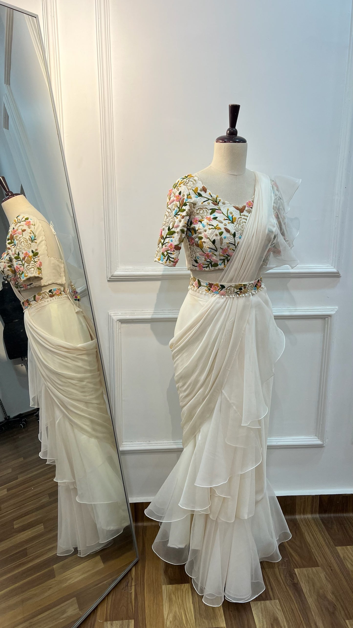 Off White Ruffle Saree paired with raw silk thread and knot work blouse