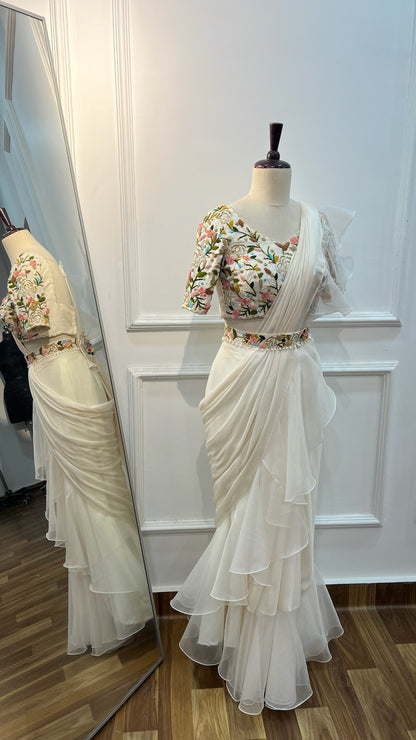 Off White Ruffle Saree paired with raw silk thread and knot work blouse
