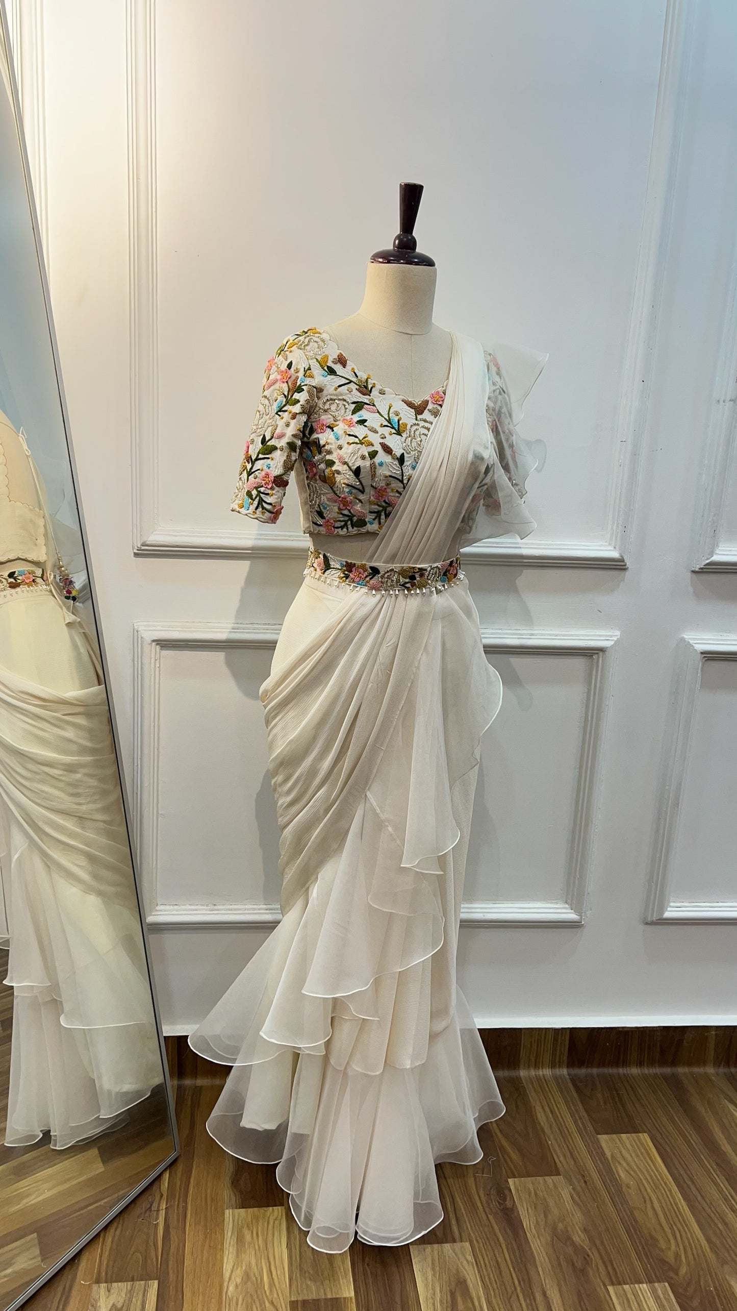 Off White Ruffle Saree paired with raw silk thread and knot work blouse