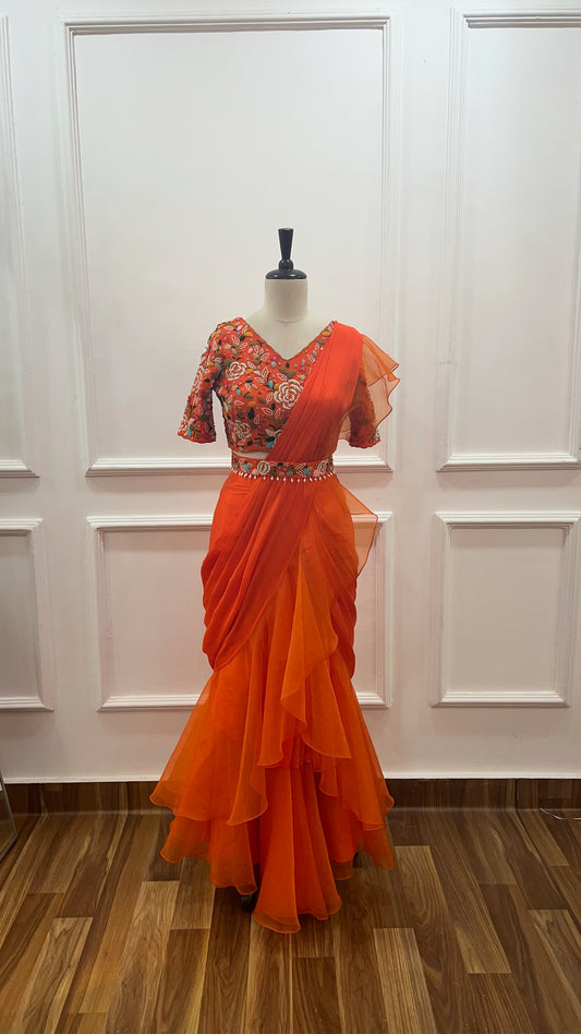 Orange Pre Draped Ruffle Saree paired with raw silk thread and knot work blouse